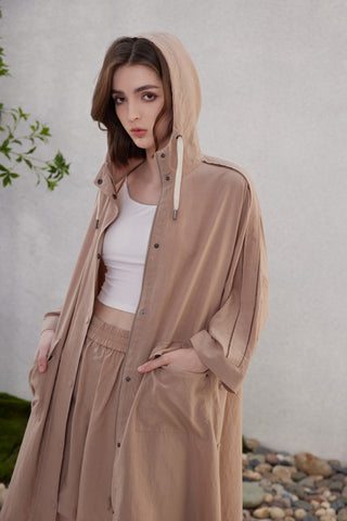 Brown hooded longline jacket with front buttons, drawstring cords, and beaded shoulders
