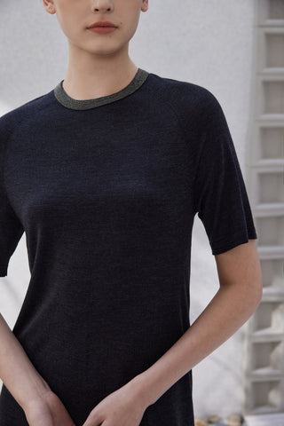 Close-up of black short-sleeve knit dress neckline with dark trim