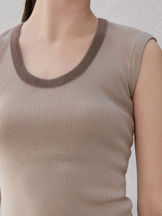 Close-up: camel tank top neckline with beaded trim and ribbed knit fabric