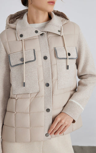 Close-up camel puffer jacket with flap chest pockets, snap buttons, and drawcords