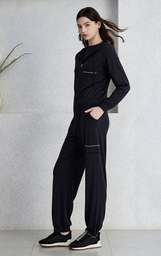Black hooded zip cardigan worn with matching joggers; long sleeves and side pockets.