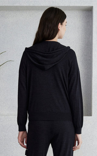 Black hooded zip knit cardigan back view with drawstring hood and ribbed cuffs.