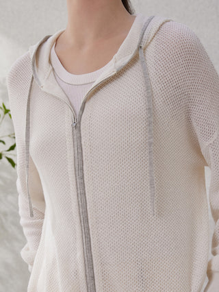 White knit hoodie close-up: full-length zipper and ribbed neckline