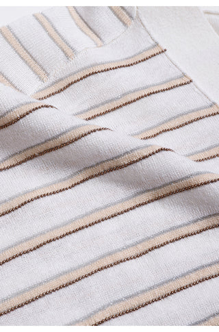 Close-up of white knit fabric with tan and blue horizontal stripe detail