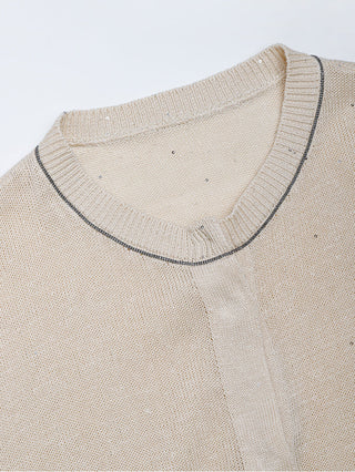 Apricot knit cardigan neckline close-up with beaded trim at the crew collar