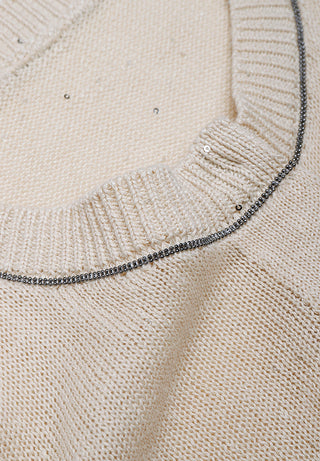 Beaded trim detail along apricot cardigan button placket, fine-gauge knit texture