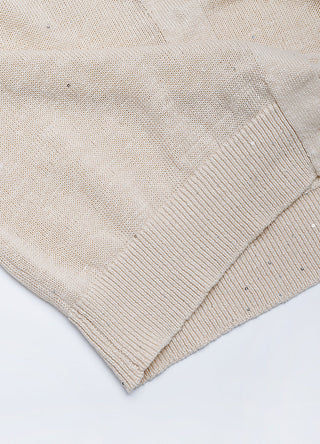 Apricot knit cardigan hem and side seam close-up, linen fine-gauge texture