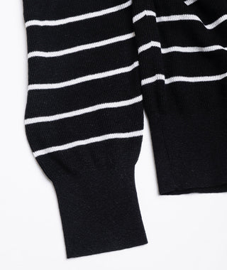 Black knit cardigan sleeve cuff with white horizontal stripes