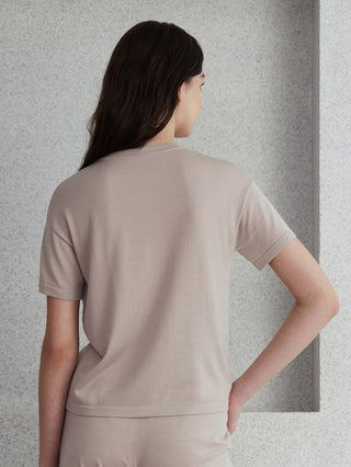 Beige wool-silk knit top back view with short sleeves and hem seam detail