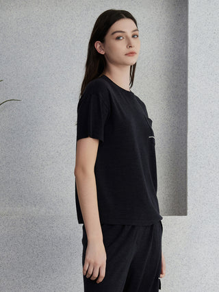 Graphite gray knit top with short sleeves, crew neck, and chest pocket with bead trim