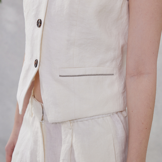 White linen vest pocket with decorative trim band and visible side seam