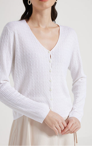 White wool-silk open-neck sweater close-up, button placket and cable-texture knit