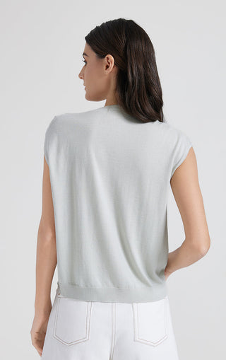 Back view of sage green short-sleeve top, draped yoke and open tie neckline