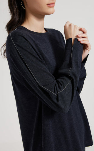 Dark knit top detail: beaded side seam along shoulder and sleeve