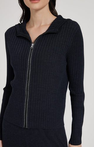 Black hooded zip knit cardigan close-up: zipper pull and ribbed knit pattern.