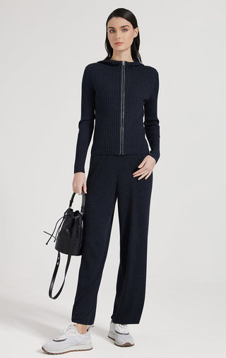 Black hooded zip rib knit cardigan with front zipper, paired with dark trousers.