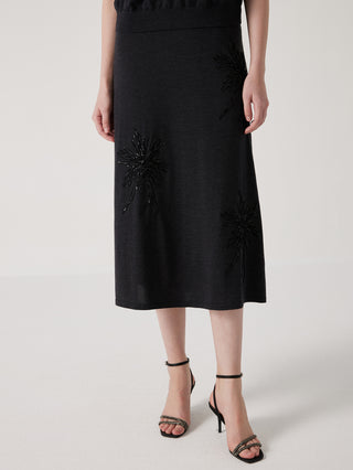 Black wool-silk midi skirt with dark starburst flower embroidery, side view
