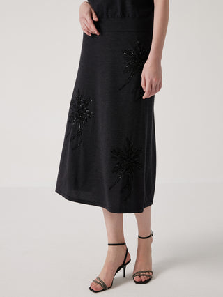 Black embroidered midi skirt with sparkling flower motifs, front three-quarter view