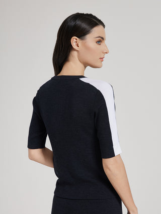 Back view of graphite gray knit top with white contrast stripe on sleeves