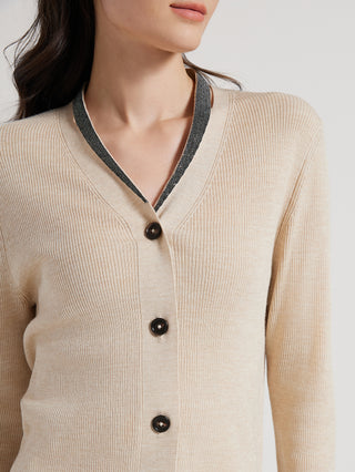 Beige wool-silk cardigan close-up: V-neck, dark trim, black button placket
