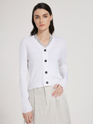 White wool-silk cardigan with black buttons, V-neck, and ribbed long-sleeve knit