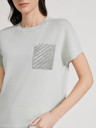 Chest detail: square sequin and beaded embroidered pocket on sage green knit T-shirt