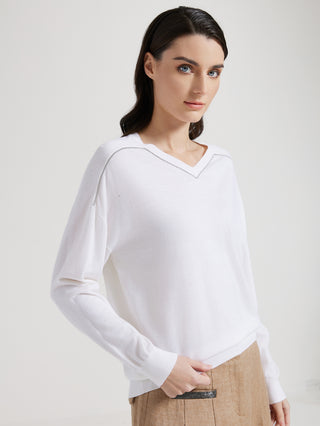 White V-neck knit top with long sleeves and beaded trim at the neckline