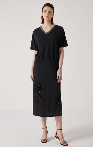 Black V-neck knit top with gray trim; beaded floral accents at side hem