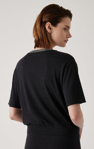 Black knit top back view with gray V-neck trim and short sleeves