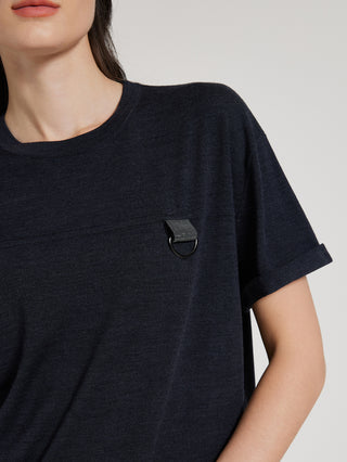 Close-up: black knit T-shirt with chest beaded ring detail near neckline