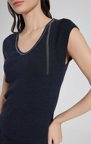 Close-up of graphite gray ribbed knit V-neck top with beaded tassel trim