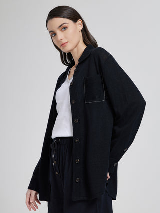 Dark gray knit shirt with long sleeves, chest patch pocket, and beaded pocket detail
