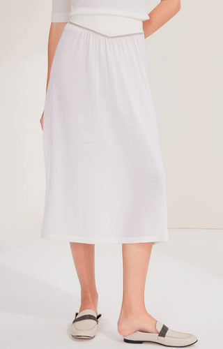 White wool midi skirt, front view with gathered elastic waist and flowing mid-calf pleats