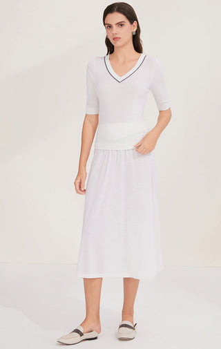 White wool midi skirt with beaded chain trim waistband, gathered and lightly pleated