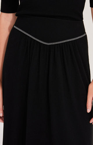 Close-up of black wool midi skirt waistband with beaded chain trim detail