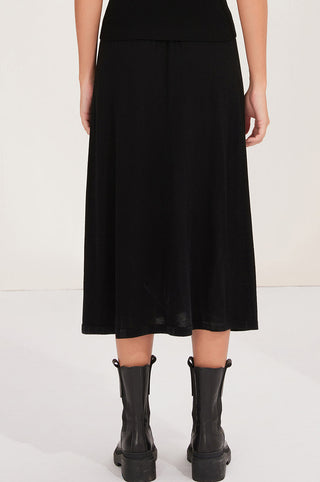 Black wool midi skirt, back view with gathered waistband and softly pleated skirt panels