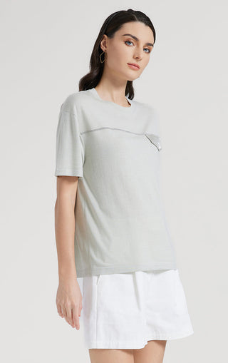 Light short-sleeve top with silver thread outlined motif on upper chest