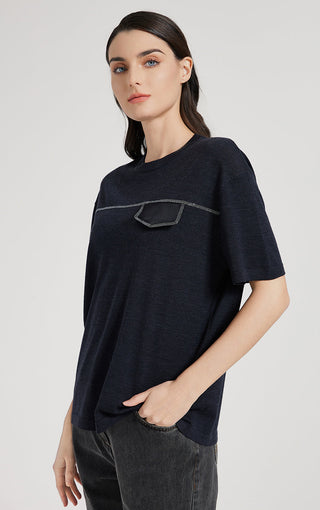 Dark short-sleeve top with outlined silver thread graphic across chest