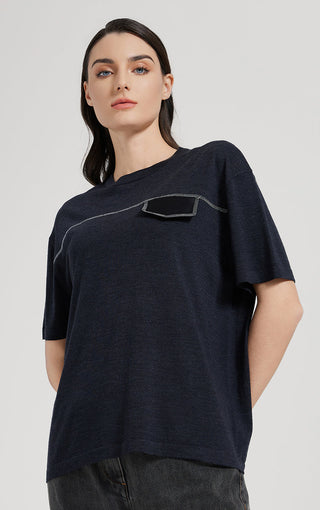 Dark short-sleeve top front view with silver thread contour lines and pocket motif