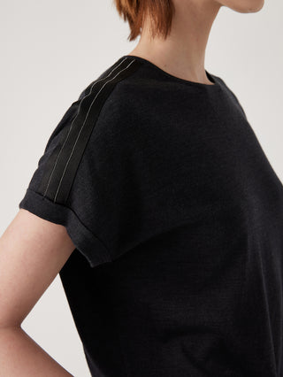 Black knit top shoulder with decorative bead trim and stitched detail