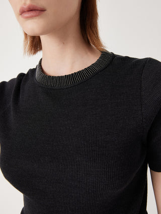 Close-up: black wool-silk knit top with beaded trim around crew neckline
