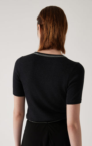 Back view of black ribbed knit top with contrasting neckline trim and short sleeves