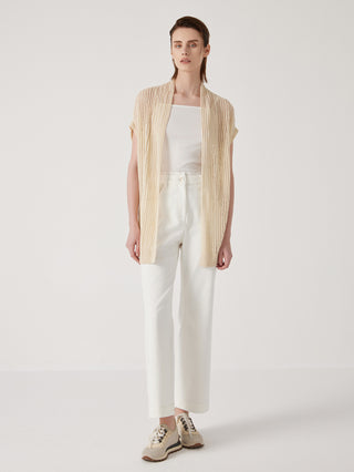 Apricot linen open-knit wrap cardigan over white pants, short sleeves and tie belt