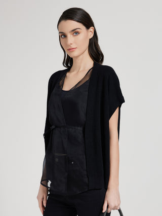 Black batwing sleeve top with V-neck, draped open front and patch pocket detail