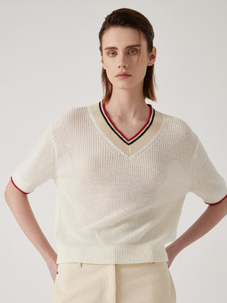 Cream ribbed knit V-neck top with striped trim and red/black edging at neckline and cuffs