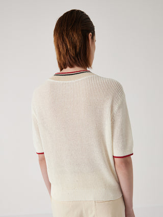 Cream ribbed knit top from the back with striped collar band and short sleeves