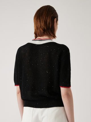 Black sequin-speckled ribbed knit top from the back with striped V-neck trim and short sleeves