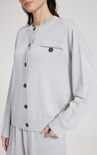 Light gray wool silk knit cardigan close-up: stand collar, black buttons, chest pocket