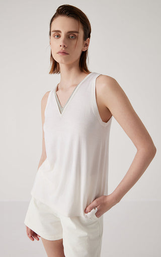 White sleeveless V-neck tank top with contrasting trim along neckline