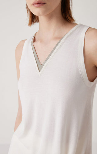 Close-up of white V-neck tank top with contrasting trim edging the V